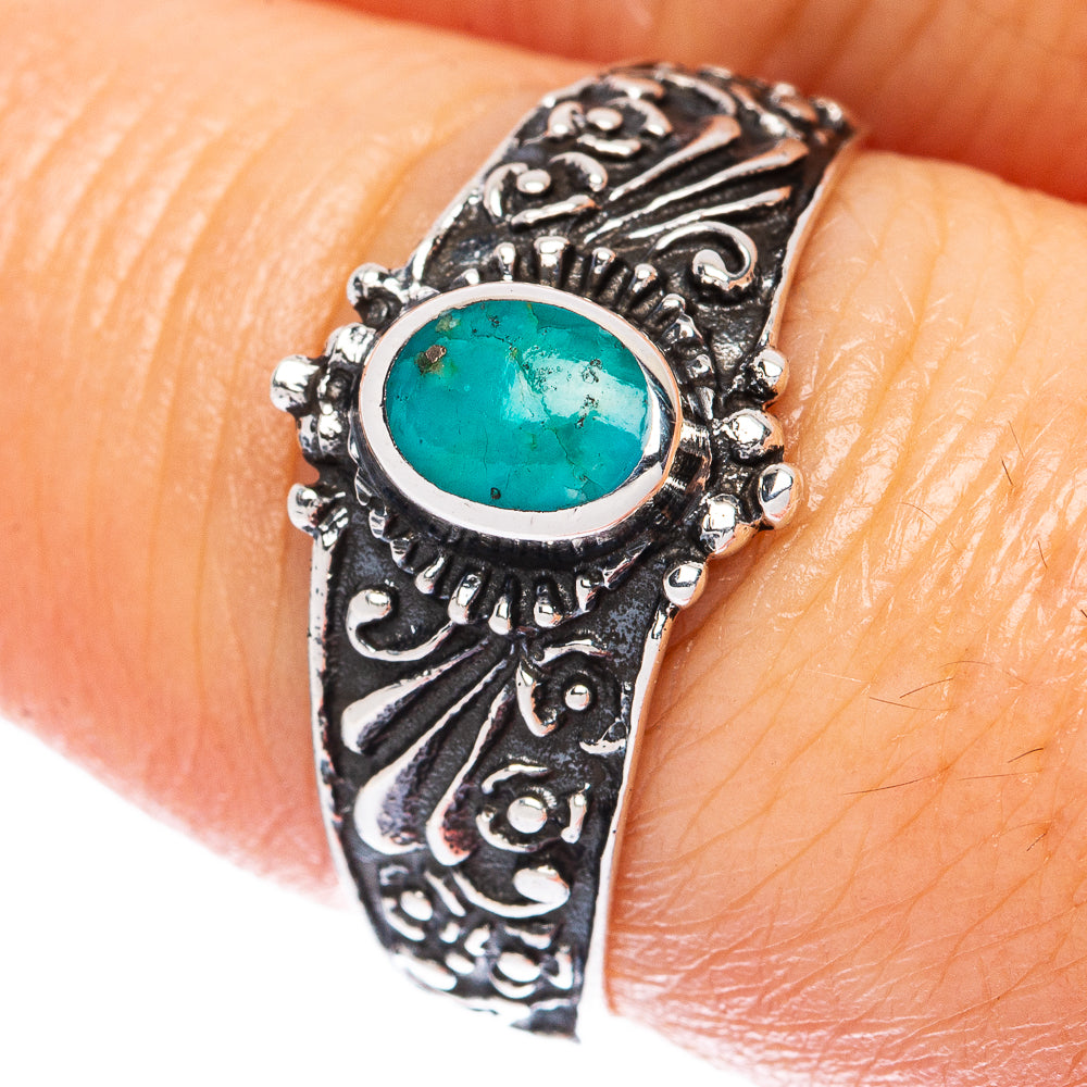 Ornate sterling silver ring with oval turquoise cabochon and engraved band