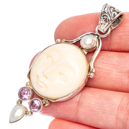 Sterling silver pendant clasp with oval carved face stone, purple amethyst and pearl drops