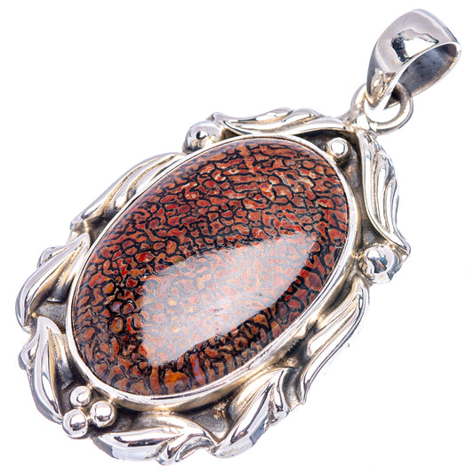 Sterling silver dinosaur bone pendant, oval red-brown stone with bail and side scrollwork