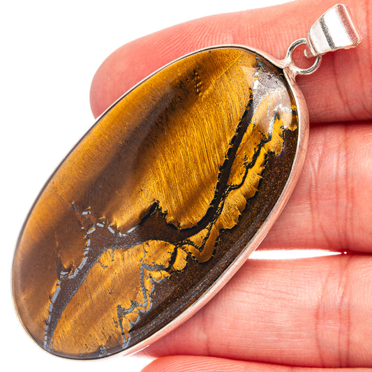 Tiger's eye pendant, oval yellow-brown stone with silver-plated bail and loop