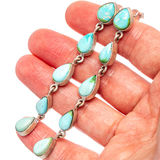 Turquoise teardrop earrings with silver drop links, hinged back and multiple charms