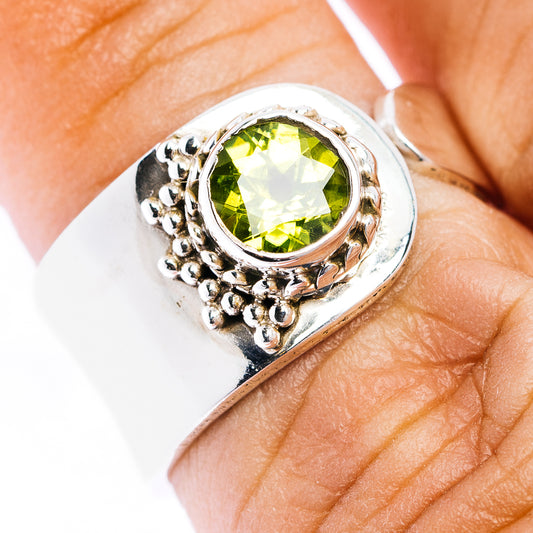 Adjustable sterling silver ring with round peridot-green gemstone and beaded halo