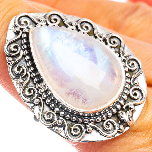 Sterling silver teardrop moonstone ring with ornate filigree and iridescent center