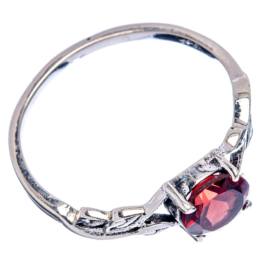Sterling silver ring with round red garnet on hinged-style band, prongs visible
