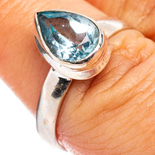 Faceted blue topaz ring with teardrop bezel setting in sterling silver