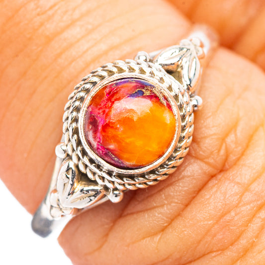 Sterling silver ring with ornate setting and oval multicolor gemstone cabochon