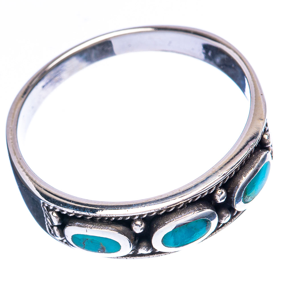 Turquoise oval stone silver band ring with decorative raised metalwork