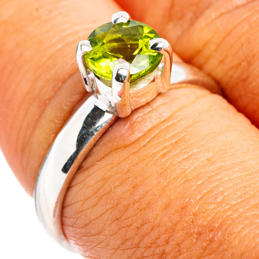 Sterling silver ring with square faceted peridot green gemstone, four-prong setting