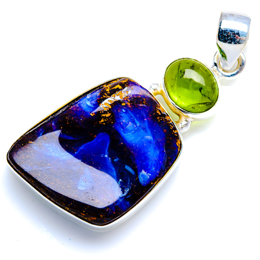 Sterling silver pendant featuring blue boulder opal with green peridot accents in bail
