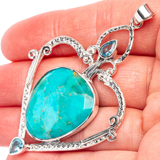 Heart-shaped sterling silver pendant with turquoise-blue cabochon and blue teardrop accents