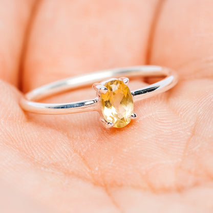 Oval citrine gemstone stackable sterling silver ring on slim band, side view