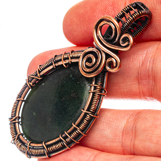 Oxidized copper wire-wrapped teardrop pendant with dark green stone and spiral accents