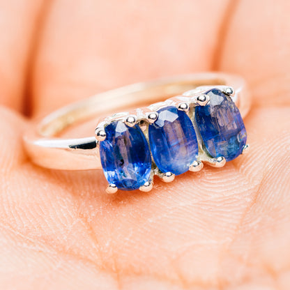 Three-stone blue kyanite ring on finger, oval stones in .925 sterling silver