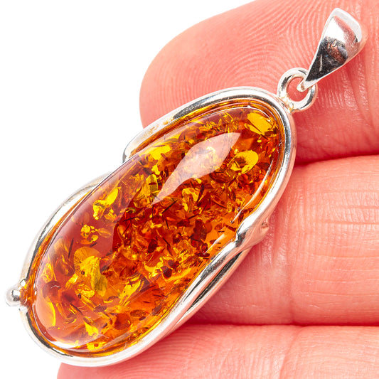 Oval Baltic amber cabochon pendant with .925 sterling silver bail and bezel setting