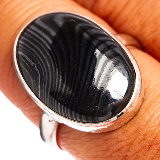 Oval black psilomelane gemstone set in a .925 sterling silver ring, size 8.75.