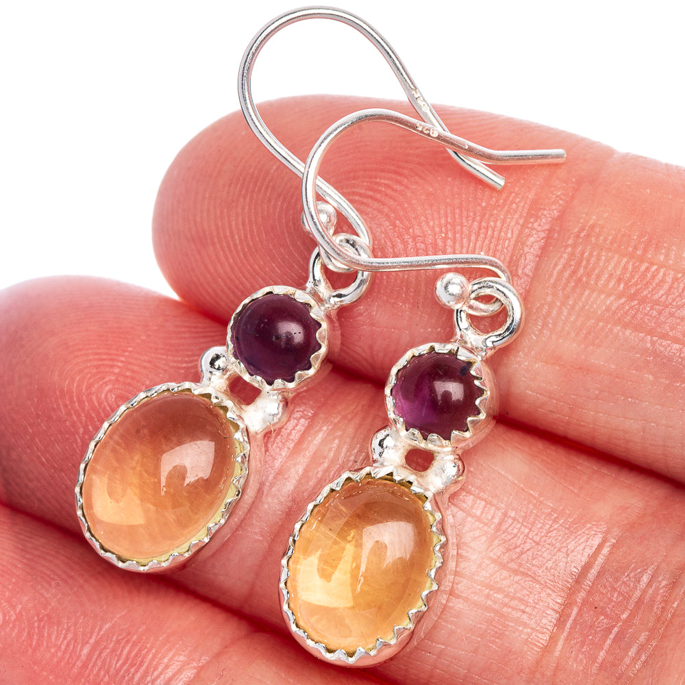 Sterling silver drop earrings with purple and orange round gemstones in scalloped settings