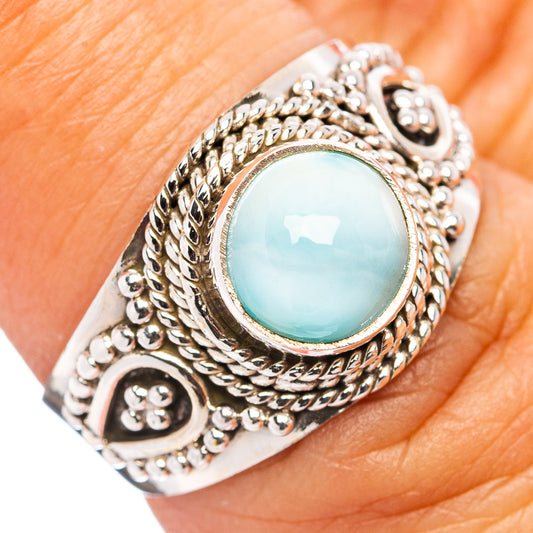 Sterling silver ring with oval turquoise cabochon center and detailed rope bezel