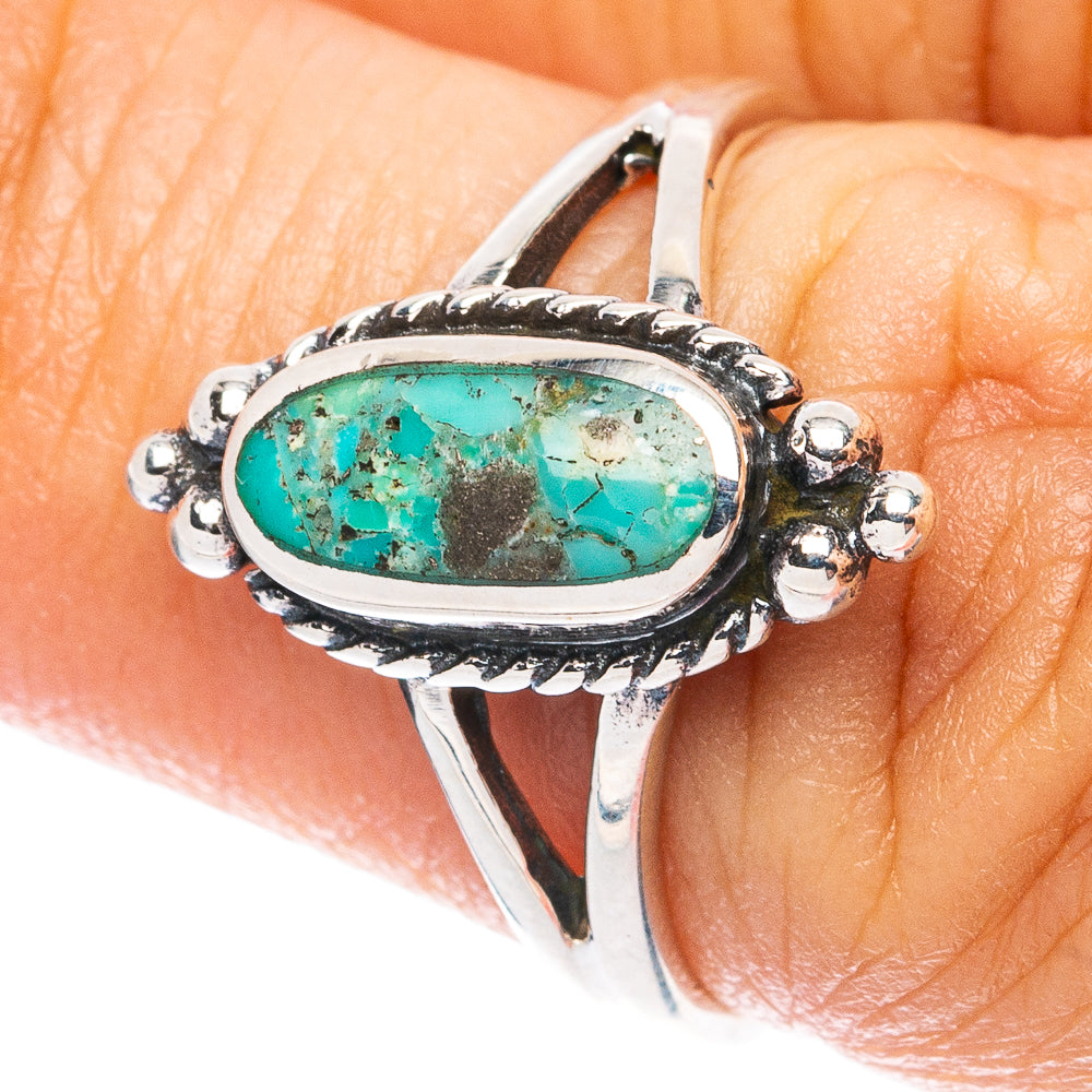 Sterling silver ring with oval turquoise cabochon, ornate side bezels, size 6.5