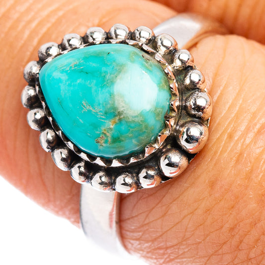 Close-up of turquoise oval cabochon sterling silver ring with bead gallery border