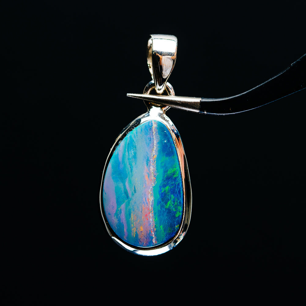 Sterling silver fire opal pendant with teardrop blue-green rainbow, top bail