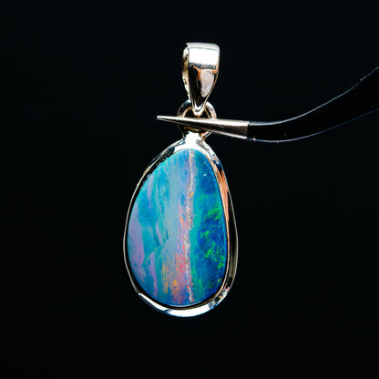 Sterling silver fire opal pendant with teardrop blue-green rainbow, top bail