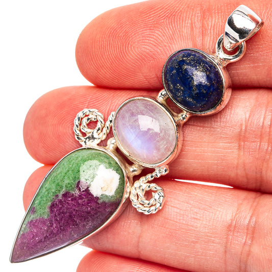 Sterling silver gemstone pendant with 3 cabochons: dark blue, pale pink, purple-green.