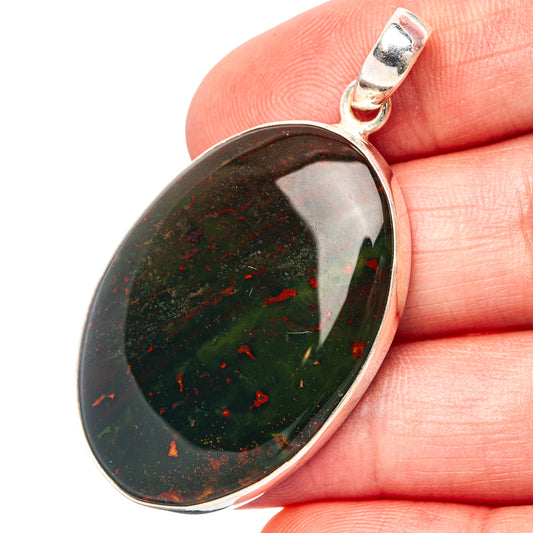 Oval bloodstone pendant in silver bezel, dark green with red speckle pattern