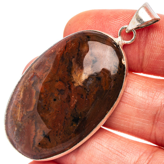 Silver-plated red jasper oval pendant with dark speckled stone and bail loop