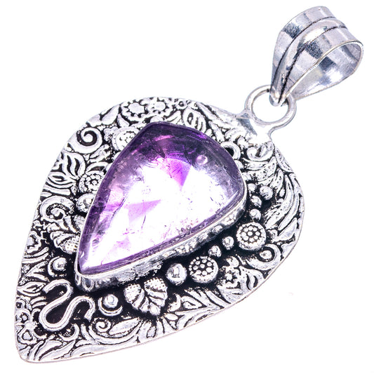 Amethyst pendant in German silver with teardrop purple stone and decorative swirl pattern