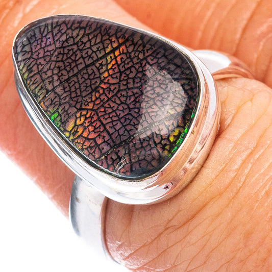 Sterling silver oval opal cabochon ring with colorful mosaic iridescence on finger