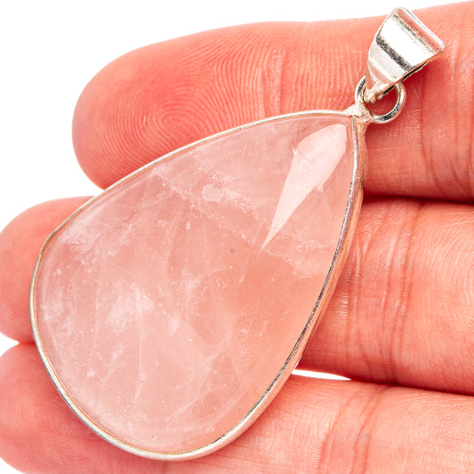 Teardrop rose quartz pendant in silver-tone bezel, with top loop