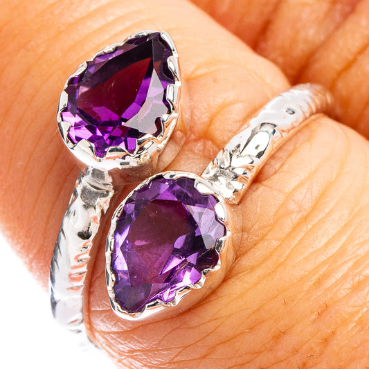 Amethyst and sterling silver double-stone ring with faceted purple gems on band.