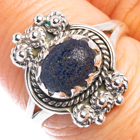 Sterling silver ring with oval dark blue lapis and ornate floral halo setting