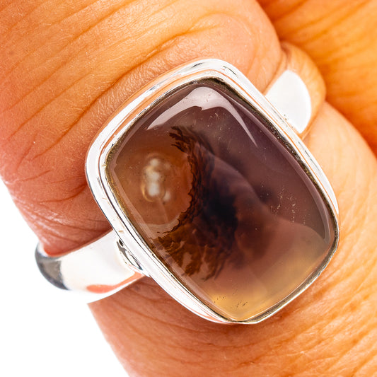 Sterling silver bezel-set oval agate ring with dark brown and amber translucent stone