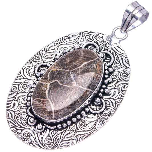 Fossil coral cabochon pendant with openwork oval filigree border and bail, German silver