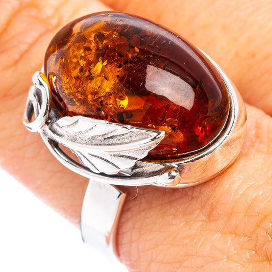 Adjustable .925 sterling silver ring with oval amber stone and leaf detail