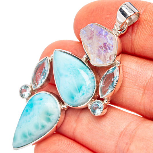 Sterling silver pendant close-up with aqua teardrop stones and small round blue gemstones