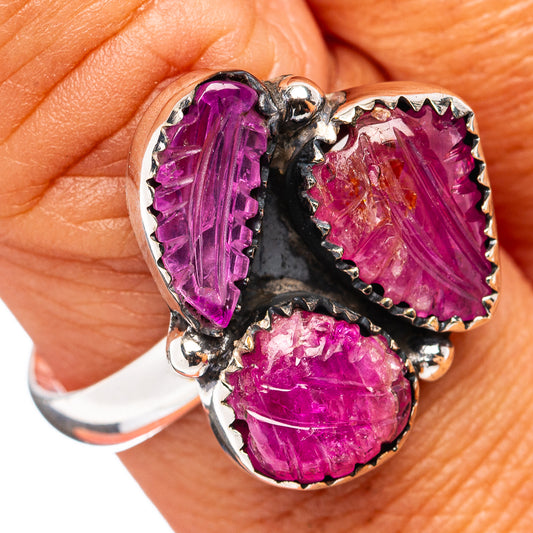 Sterling silver ring with three carved purple ruby stones, scalloped metal prongs