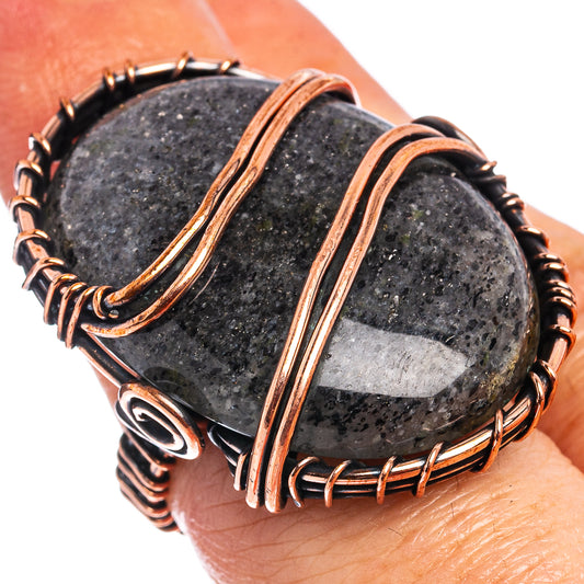 Oxidized copper wire wrap ring with dark oval stone, braided copper bands