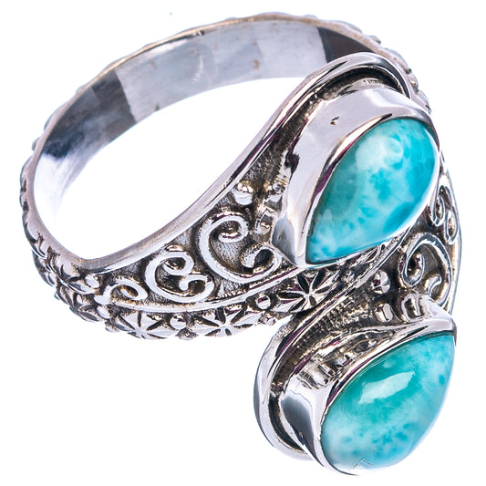 Sterling silver ring with two stacked oval blue stones and engraved filigree detailing