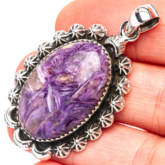 Oval charoite pendant in .925 sterling silver with ornate floral edge and top bail