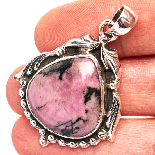 Rhodonite pendant in 925 sterling silver with round pink cabochon and ornate bezel