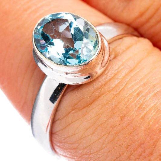 Sterling silver ring with faceted light-blue topaz gemstone, round setting