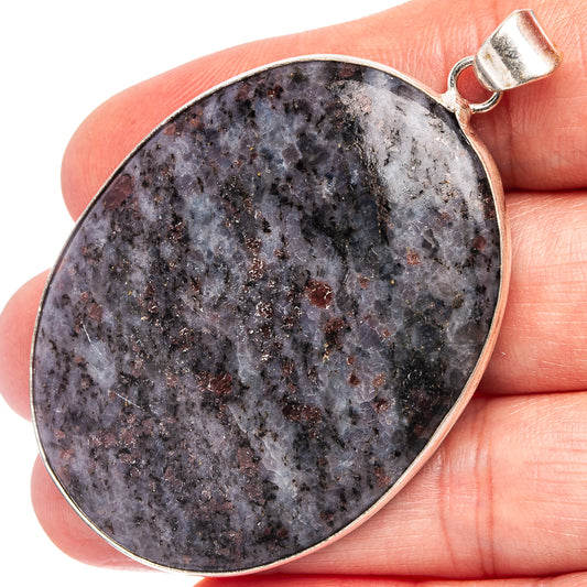 Silver-plated oval cabochon pendant with dark speckled palm stone and metal bail