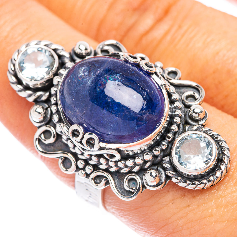 Sterling silver oval blue gemstone ring with three round clear stones, size 7.75
