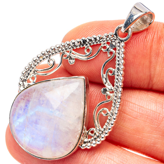 Sterling silver teardrop moonstone pendant with filigree chain and rainbow shimmer.