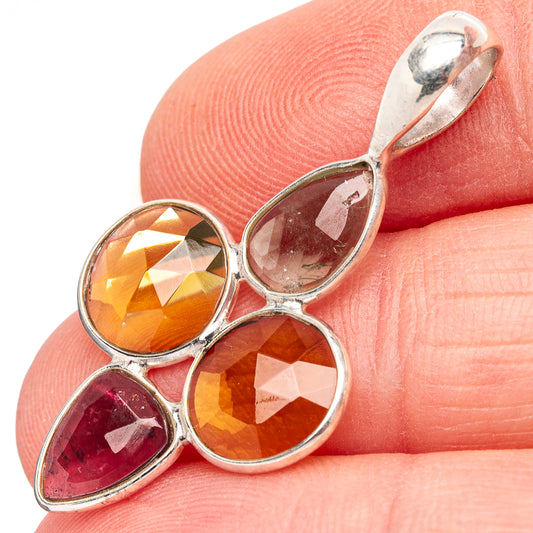 Sterling silver tourmaline pendant showing faceted orange and red teardrop stones in bezel