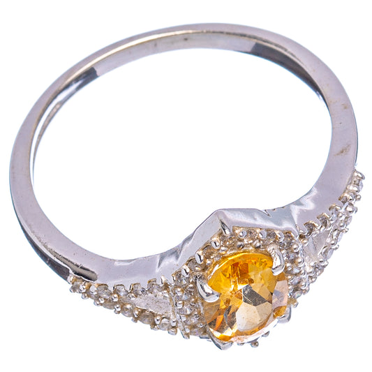 Oval citrine solitaire ring with cubic zirconia side accents on sterling silver band