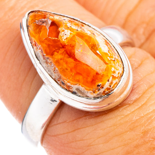 Sterling silver ring with oval orange fire opal cabochon, side view detail.