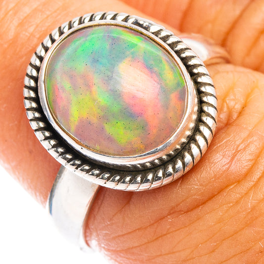 Sterling silver opal ring with oval multicolor cabochon and rope bezel